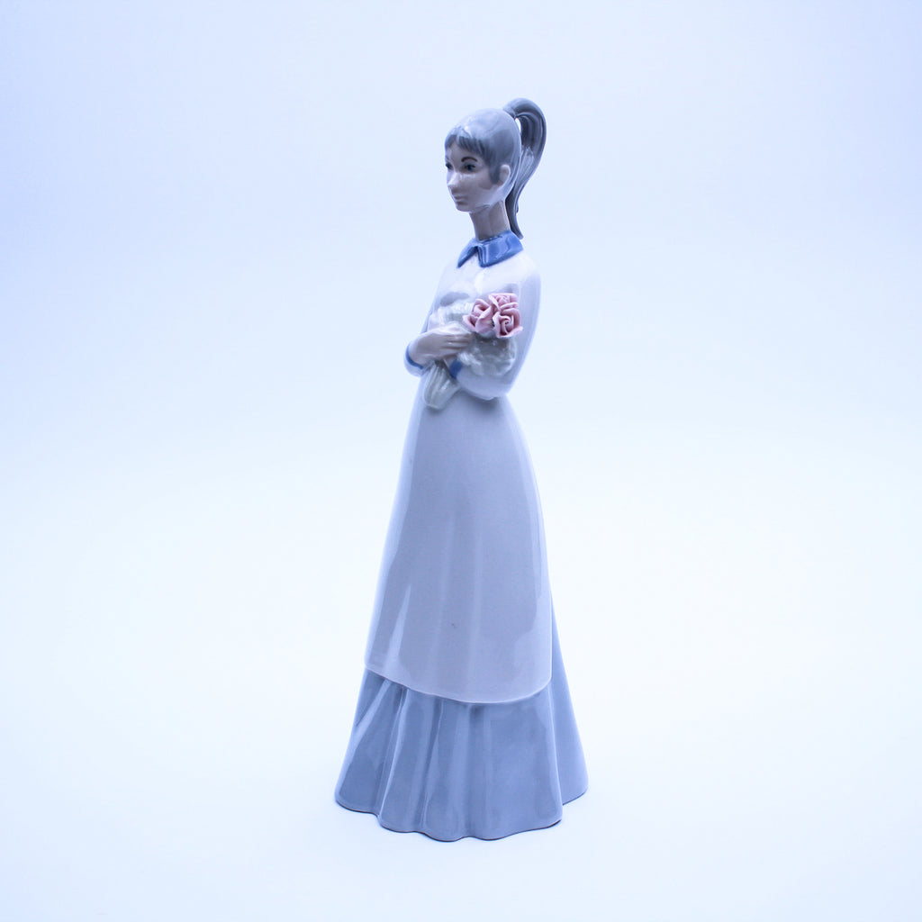 Springtime Serenity – Lladró-Style Porcelain Girl Holding Flowers